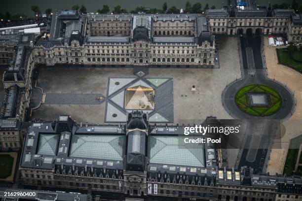 Photograph taken from an helicopter on July 26, 2024 shows an aerial view of the Pyramide du Louvre, designed by Chinese-US architect Ieoh Ming Pei,...