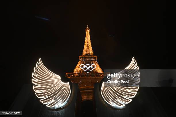 General view shows the Eiffel Tower with illumated wings in the foreground during the Opening Ceremony of the Olympic Games Paris 2024 on July 26,...