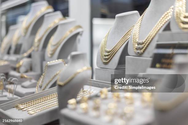 jewelry diamond rings and necklaces show in luxury retail store window display showcase - jewelry stock pictures, royalty-free photos & images