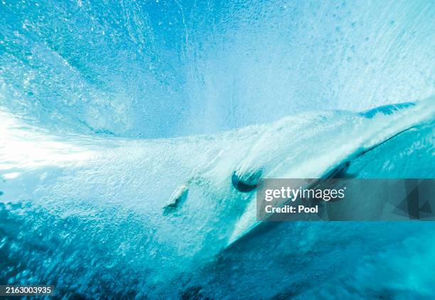 Australia's Molly Picklum rides a wave during a surfing training session ahead of the Paris 2024 Olympic Games on July 26, 2024 in Teahupo'o, French...