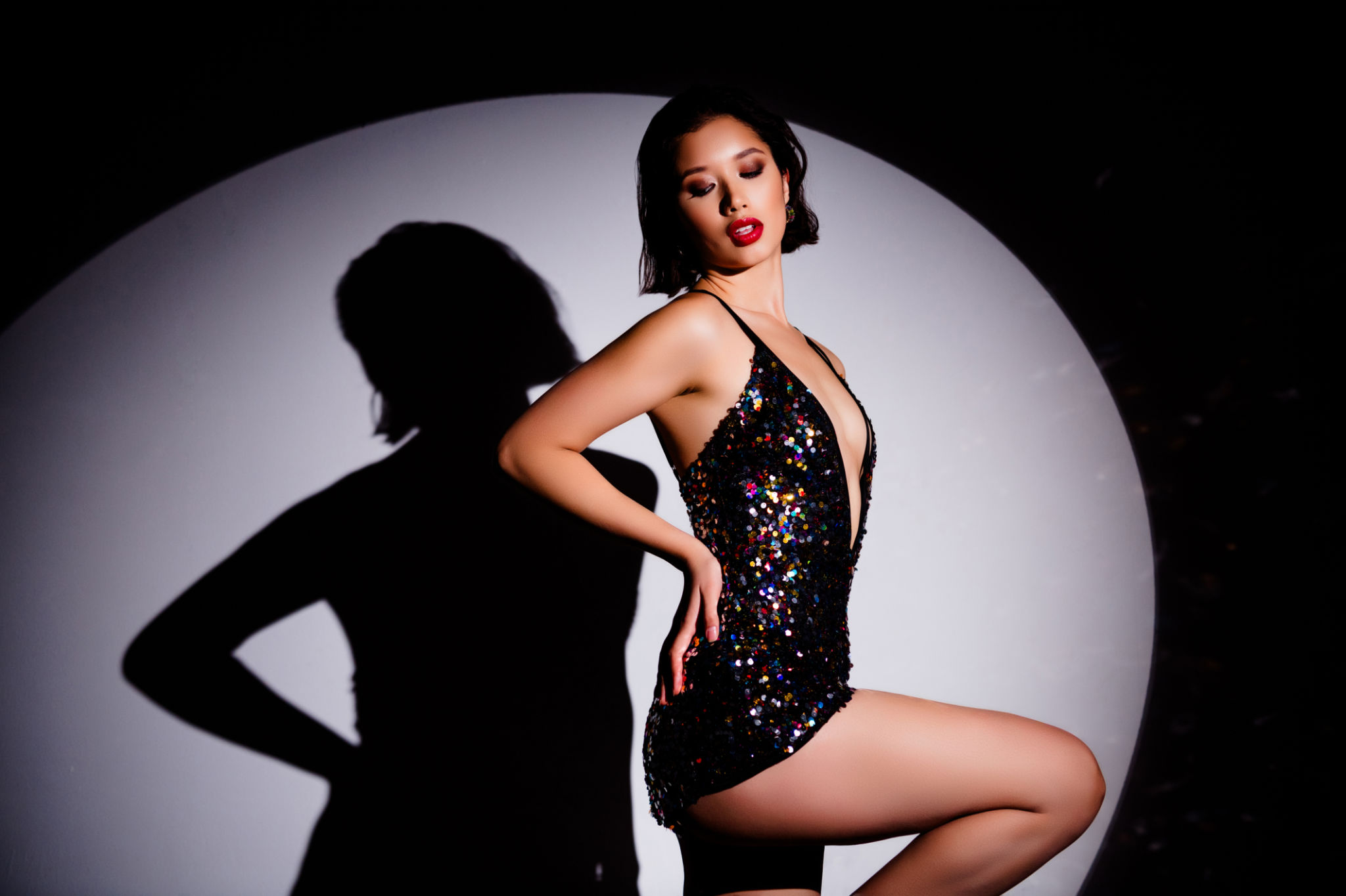 Profile portrait of charming famous movie actress hand touch waist posing shadow silhouette spotlight Profile portrait of charming famous movie actress hand touch waist posing shadow silhouette spotlight