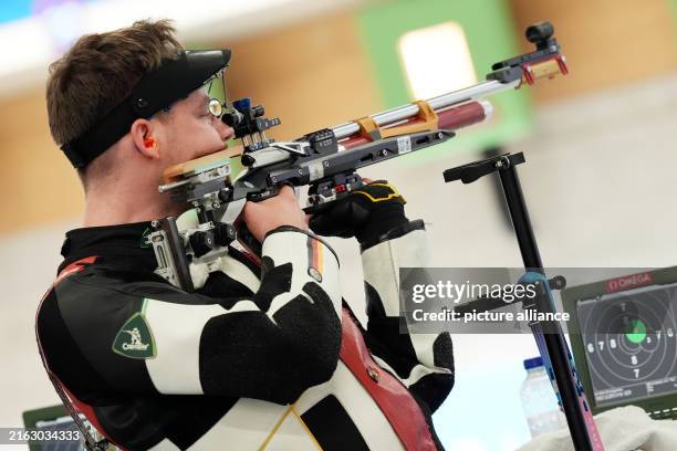 July 2024, France, Paris: Germany's Maximilian Ulbrich competes in the mixed team qualification Air rifle 10m Shooting Preliminary competition at...