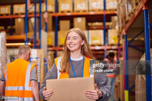 happy young warehouse worker - delivery person portrait stock pictures, royalty-free photos & images
