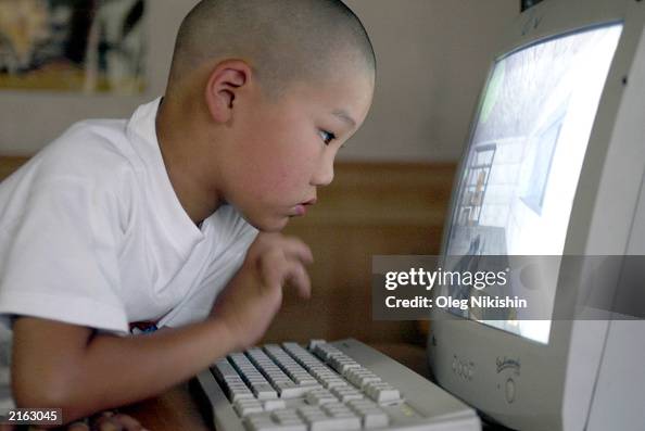 A Mongolian child plays a computer game at an Internet cafe July 15 ...