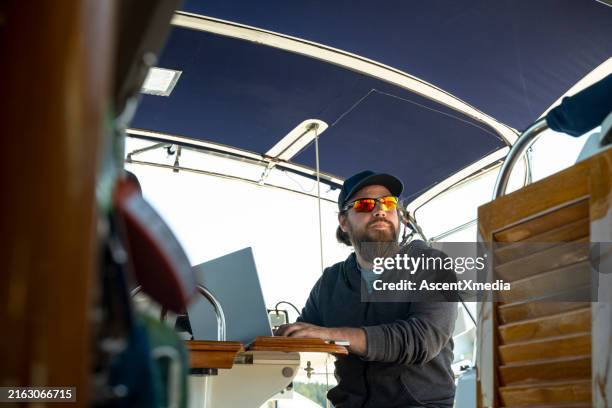 portrait of captain steering boat - ship captain wheel stock pictures, royalty-free photos & images