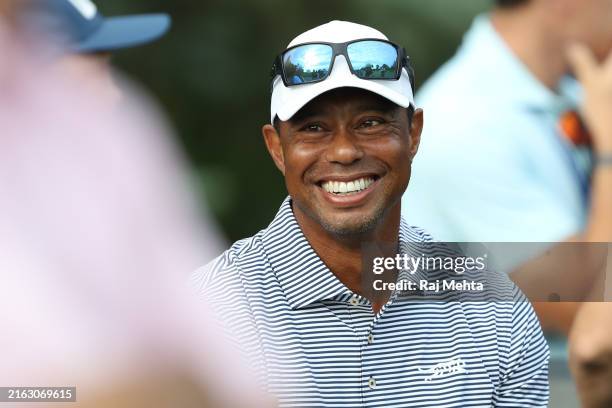 Tiger Woods of the United States talks with spectators near the putting green on day one of the 76th U.S. Junior Amateur Championship on the North...