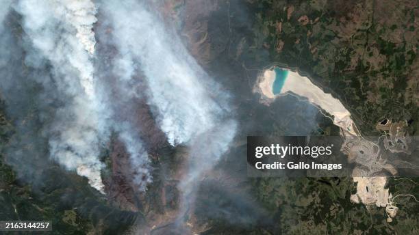 Satellite image shows the Shetland Creek wildfire near the Highland Valley Copper mine, north of Spences Bridge, British Columbia, Canada. Imaged 20...