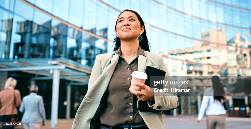 Confident Businesswoman Walking with Coffee Outside Modern Office Building