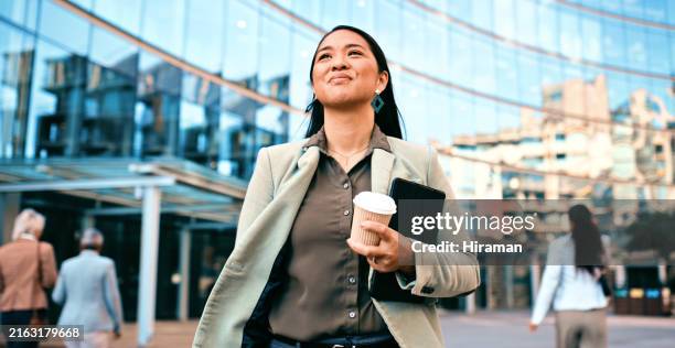 confident businesswoman walking with coffee outside modern office building - happy colleagues doing team building activity imagens e fotografias de stock