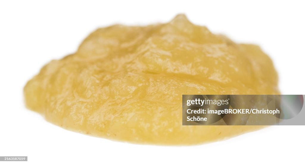 Homemade Applesauce (selective focus) isolated on white background (close-up shot)