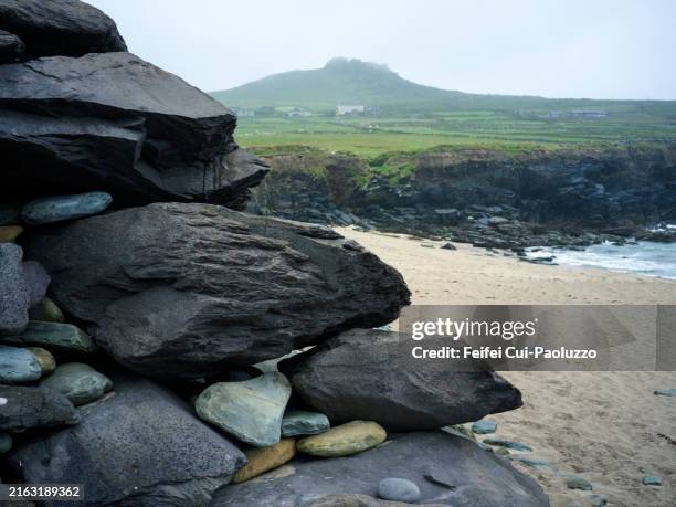 tourist on the beach of slea head - slea head stock pictures, royalty-free photos & images