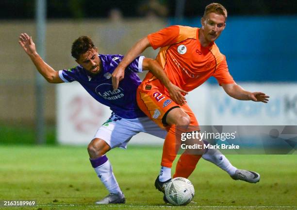 Ben Halloran of the Brisbane Roar competes with Jarrod Caluccio of Perth Glory during the Australia Cup Play-Off match between Brisbane Roar and...