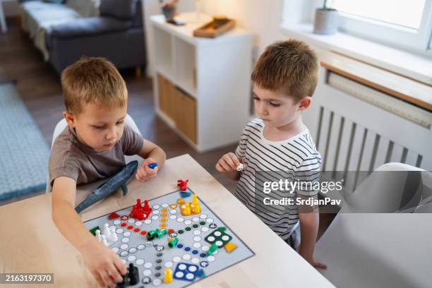 kids playing ludo game at home - ludo stock pictures, royalty-free photos & images