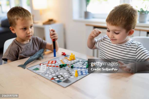 kids playing ludo game at home - ludo stock pictures, royalty-free photos & images