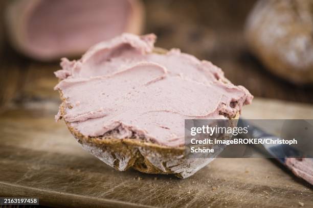 roll with liverwurst (german cuisine) on an old wooden table as detailed close-up shot (selective focus) - leberwurst foto e immagini stock