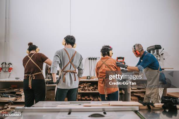 asian carpenter conducting woodwork classes to senior student in woodshop workshop - workbench stock pictures, royalty-free photos & images