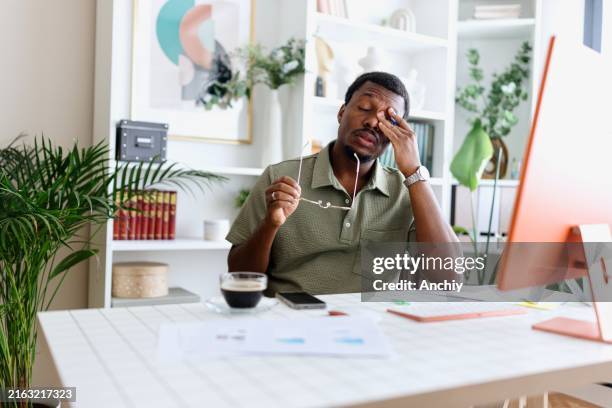 man taking a break from work at home - trött bildbanksfoton och bilder