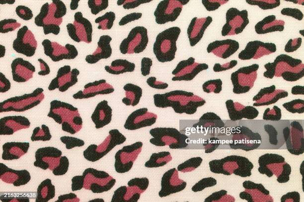 leopard print fabric closeup - cheetah print stock pictures, royalty-free photos & images
