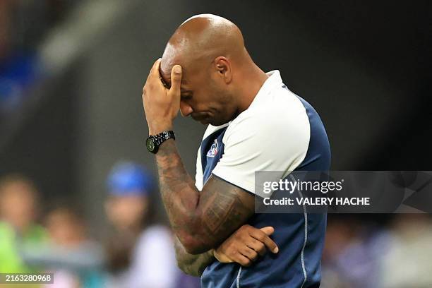 France's coach Thierry Henry reacts on the sidelines in the men's group A football match between France and Guinea during the Paris 2024 Olympic...