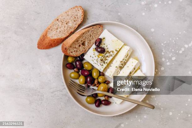 black and green olives with feta cheese, olive oil and aromatic herbs , healthy food , healthy diet - feta cheese stock pictures, royalty-free photos & images