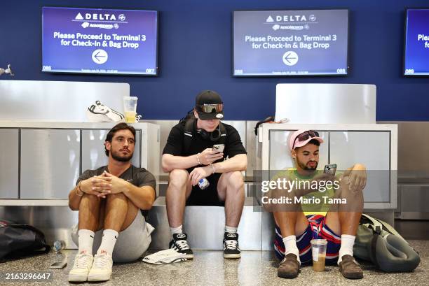Travelers from France wait on their delayed flight on the check-in floor of the Delta Air Lines terminal at Los Angeles International Airport on July...