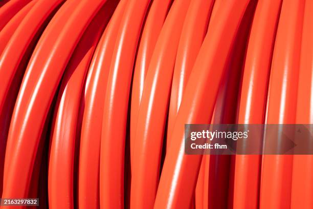 rolled up red cabel on a cable drum - cable tv stock pictures, royalty-free photos & images