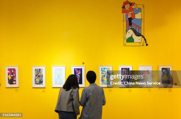 Visitors view paintings during an art exhibition at Ayala Museum in Makati Central Business District on July 23, 2024 in Manila, Philippines.