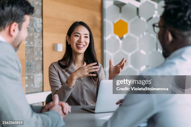 group of business persons talking in the office. - asiático e indiano imagens e fotografias de stock