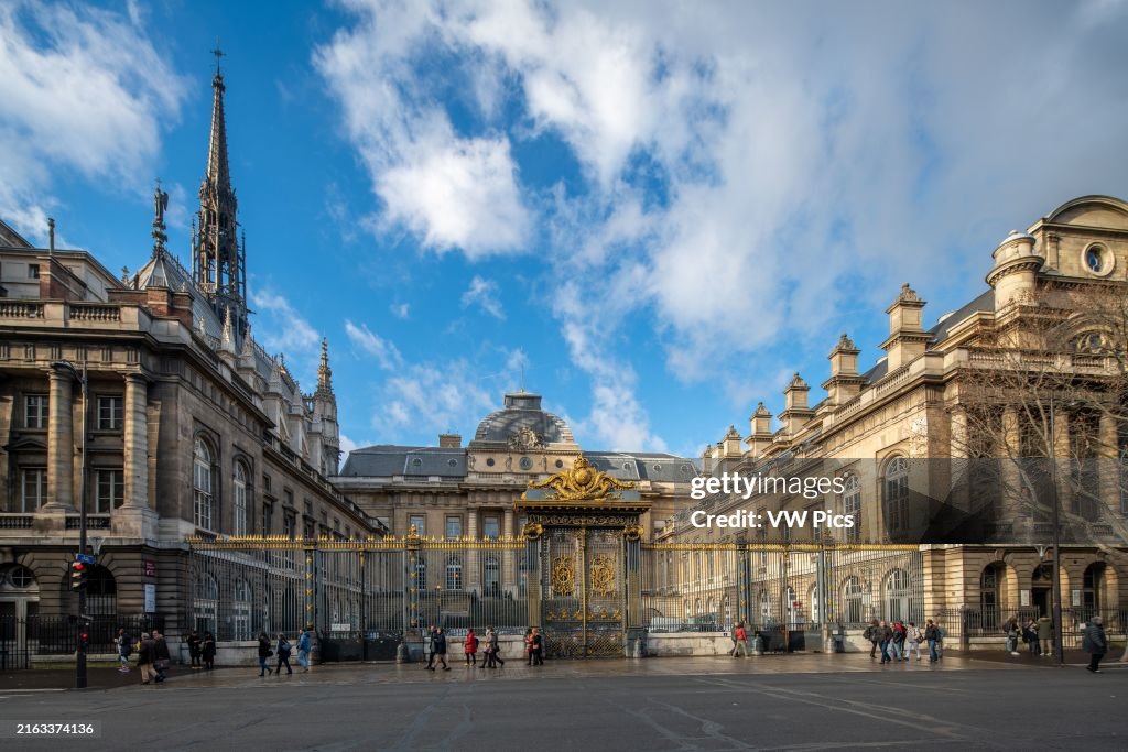 Sunlight bathes Lutece Street with views of Sainte Chapelle and Palais de Justice on Île de la Cité