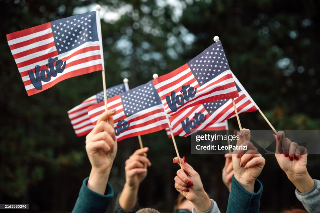 People waving presidential election US Flags