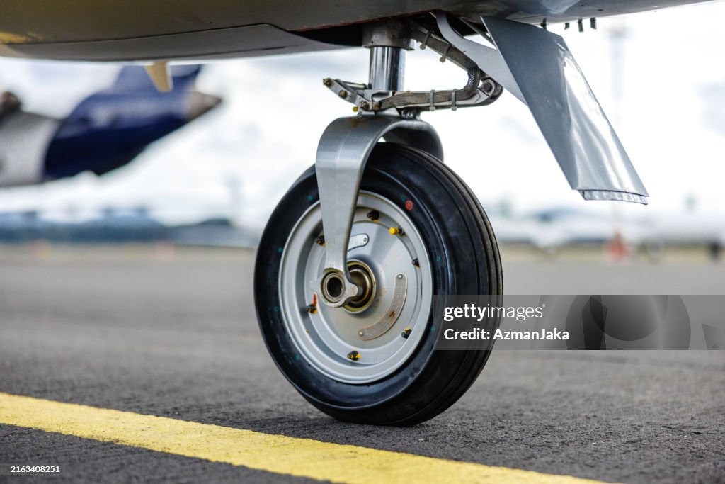 Close-Up of Airplane Landing Gear on Tarmac