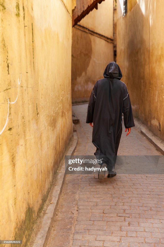 Maroccan man walking in Medina of Fes, Morocco
