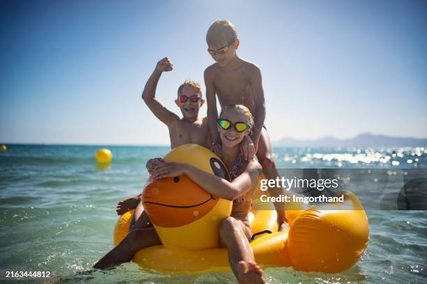 kids enjoying summer beach vacation at sea. - rubber duck stock pictures, royalty-free photos & images