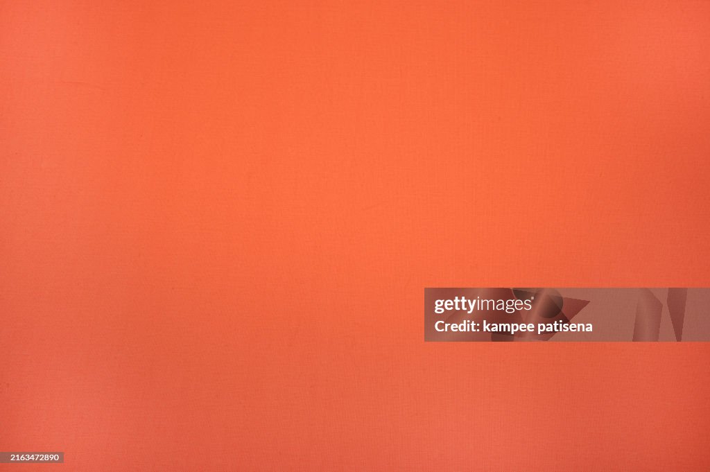The orange background is a vibrant canvas