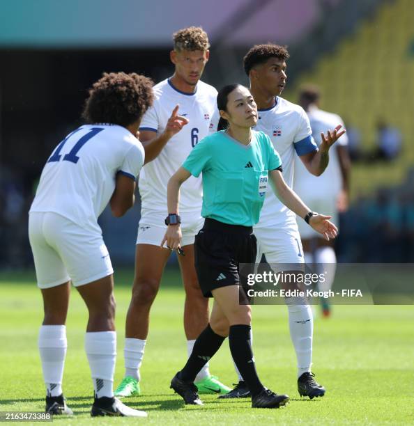Referee Yoshimi Yamashita looks on as Peter Gonzalez of Team Dominican Republic reacts during the Men's group C match between Egypt and Dominican...