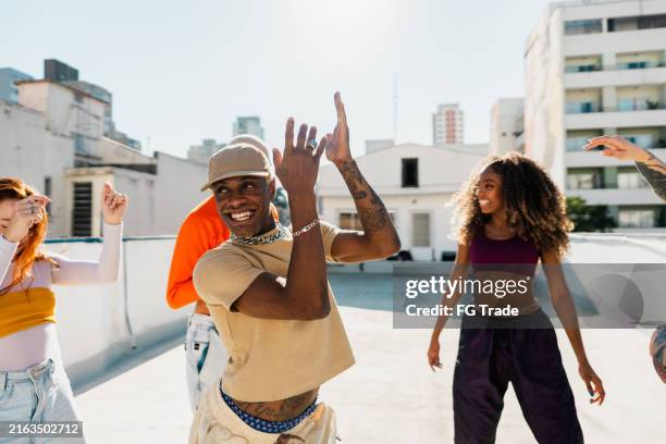 young man dancing at rooftop - entertainment occupation stock pictures, royalty-free photos & images