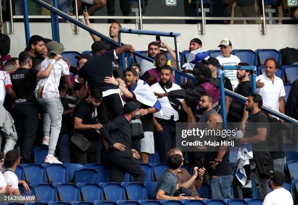 Fans fight in the stands as security staff separate them prior to the Men's group D match between Mali and Israel during the Olympic Games Paris 2024...
