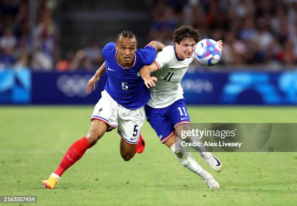 Kiliann Sildillia of Team France is challenged by Paxten Aaronson of Team United States during the Men's group A match between France and United...