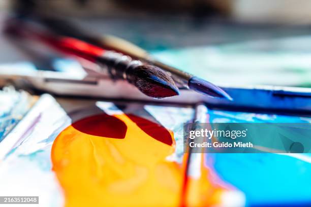 brush and watercolour pallette in artist studio. - artists palette stock pictures, royalty-free photos & images