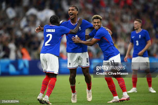 Loic Bade of Team France celebrates scoring his team's third goal with teammates during the Men's group A match between France and United States...
