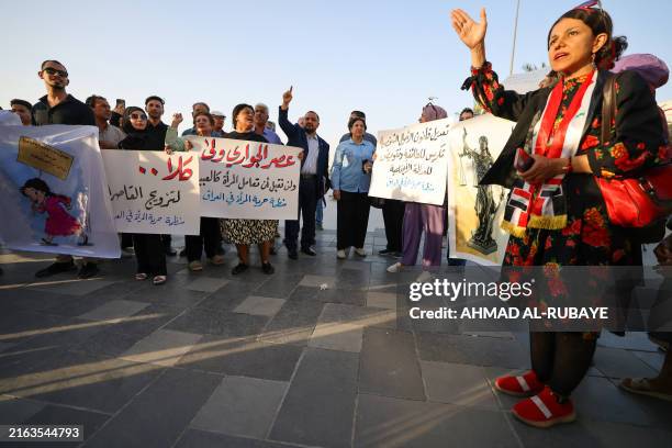 Activists demonstrate against female child marriages in Tahrir Square in central Baghdad on July 28 amid parliamentary discussion over a proposed...
