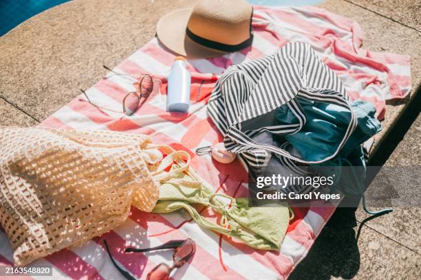 top down view beach accessories on towel poolside - tote bag stock pictures, royalty-free photos & images
