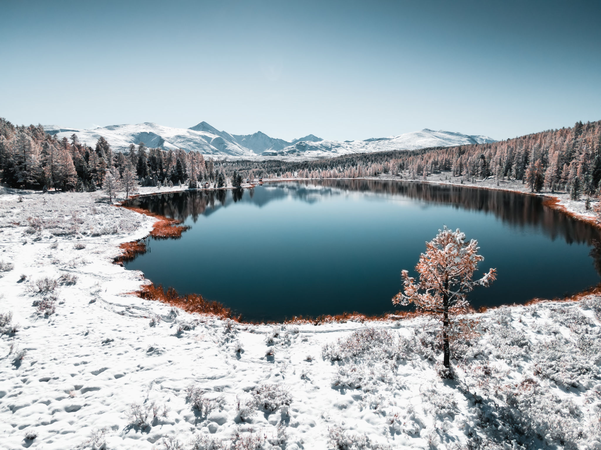 Kidelu lake in Altai mountains, Siberia, Russia. Snow-covered trees and mountains. Kidelu lake in Altai mountains, Siberia, Russia. Snow-covered trees and mountains.