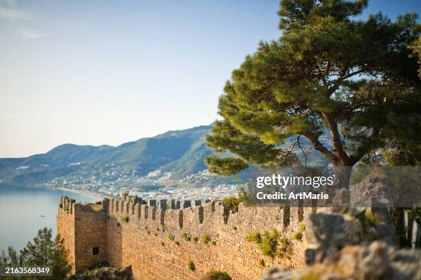 beautiful sea and mountains landscape and fortified wall of alanya castle, turkey - fortified wall stock pictures, royalty-free photos & images