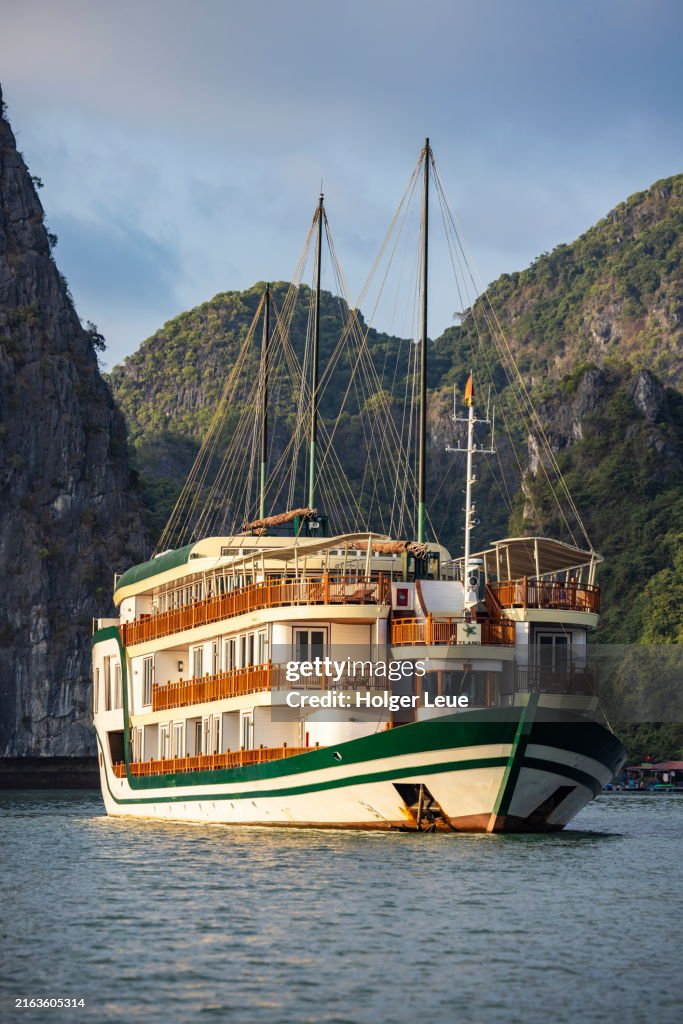 Boutique cruise ship Ylang (Heritage Line) in bay amidst karst islands