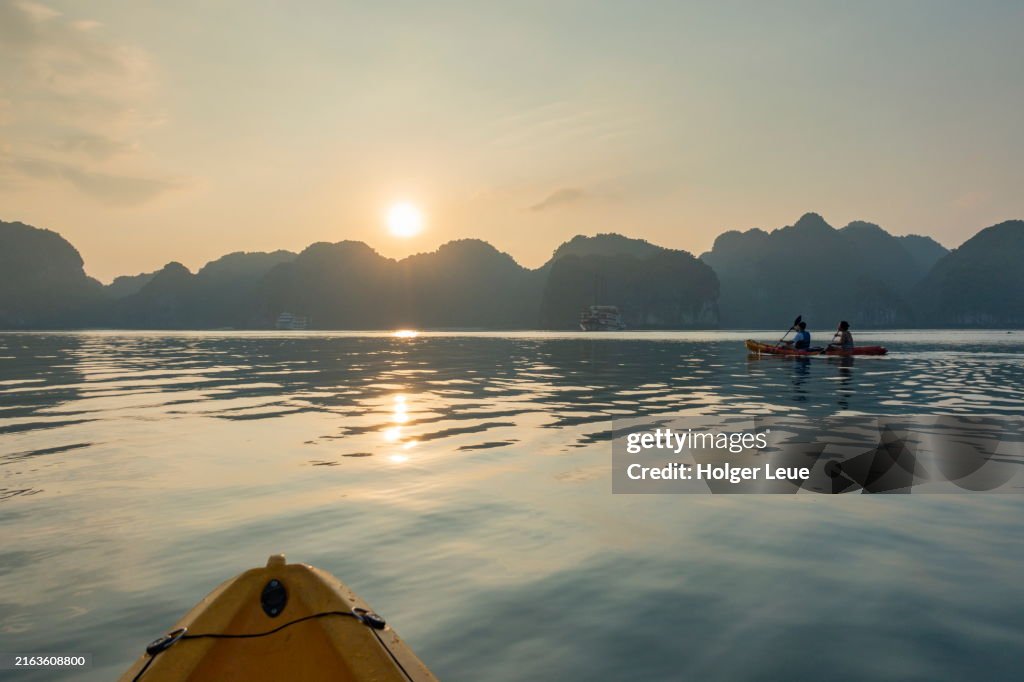 Sea kayaking excursion for passengers of boutique cruise ship Ylang (Heritage Line) at sunset