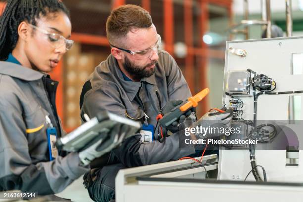 quality control engineer testing on a circuit of main distribution board at the cabinet rack in production line. - suministro de energía fotografías e imágenes de stock