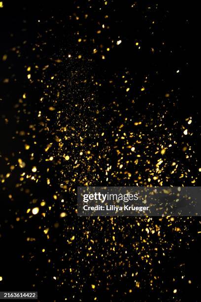 falling golden confetti on a black background. - coriandolo foto e immagini stock