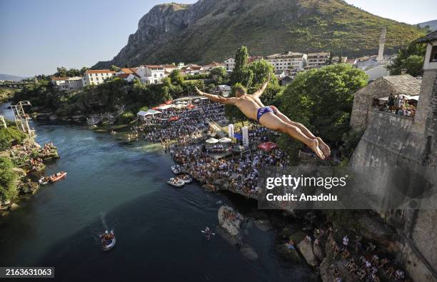 Participant dives from historical 'Old Bridge', also known as 'Mostar Bridge' during the traditional diving event, 458th Old Bridge Diving Contest,...
