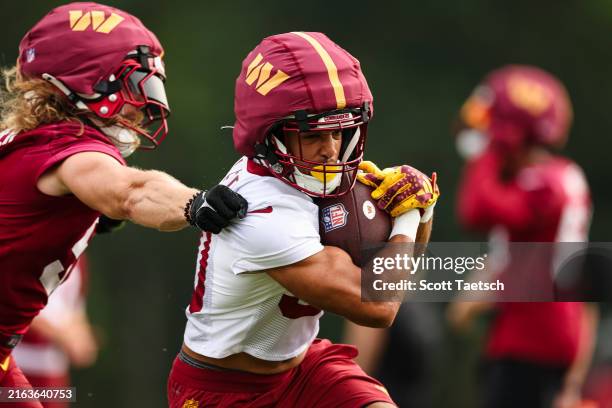 Austin Ekeler of the Washington Commanders participates in a drill during training camp at OrthoVirginia Training Center at Commanders Park on July...